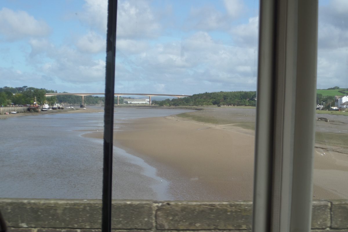 The view downstream from the middle of the old Bideford Bridge with new high-level Torridge Bridge in the distance.